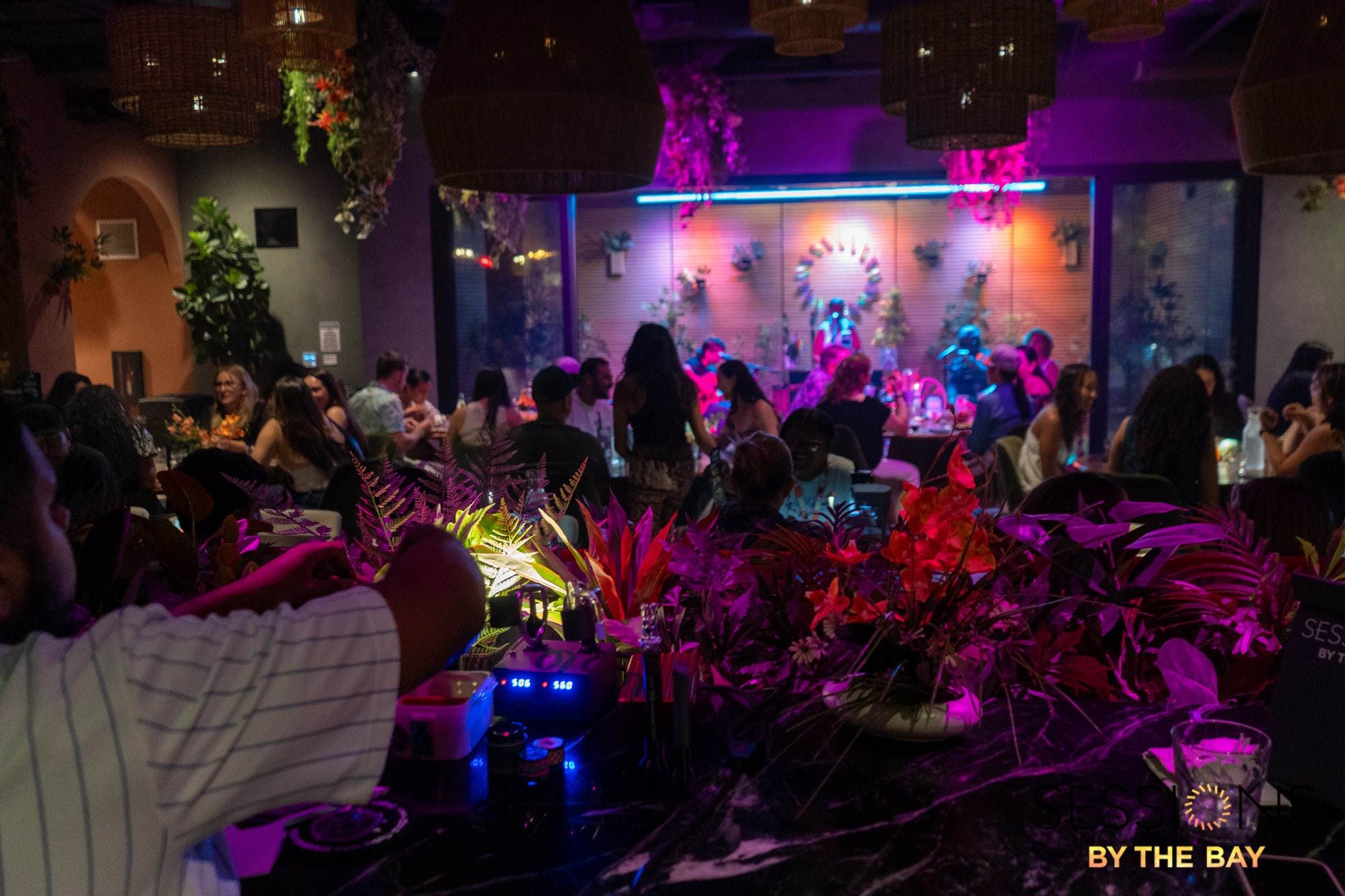 A full lounge facing the stage on a show night at Sessions By The Bay